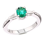 Green emerald and white diamond gold ring.